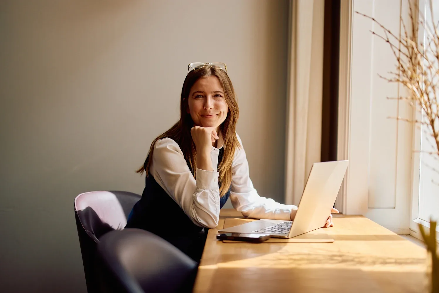Instructional designer working at a laptop, representing the human expertise that drives every KnowledgeNow learning design decision